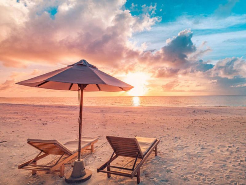 Miraval The Red Sea Beach at sunset with chairs and umbrella