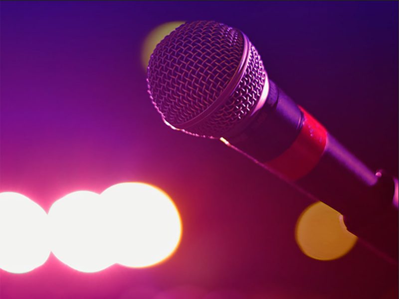 stand-up comedy night in Riyadh at AMC Cinemas: microphone in dark room