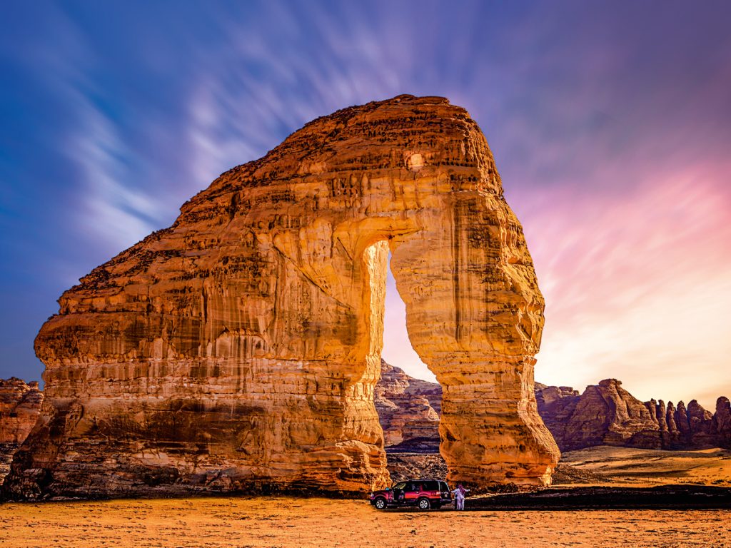 places to travel during Eid Al-Adha in Saudi Arabia: AlUla rock formation with skies