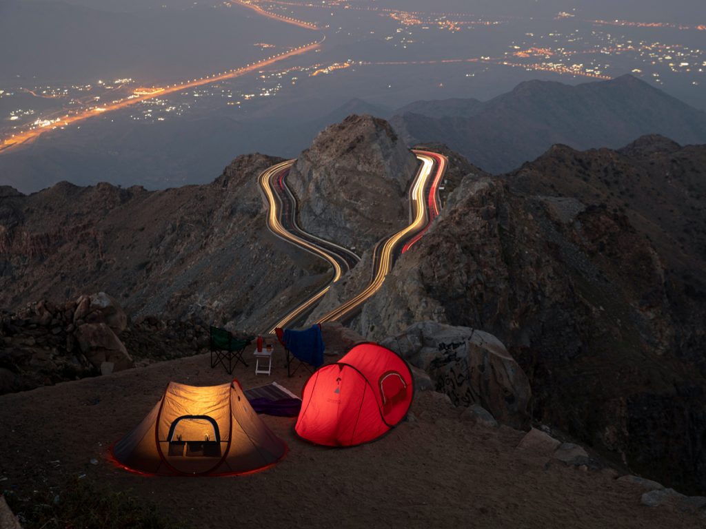 places to travel during Eid Al-Adha in Saudi Arabia Taif camping site in the mountains with car lights