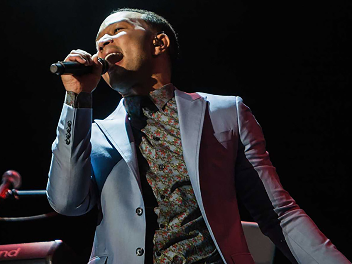 John Legend AlUla concert: singer performing live on dark stage