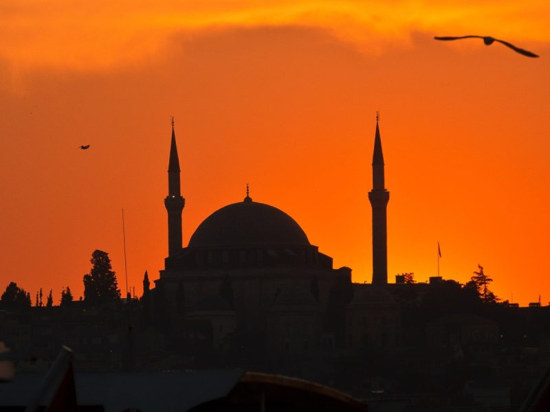 Eid Al-Adha 2023 in Saudi Arabia: mosque silhouette with orange sky